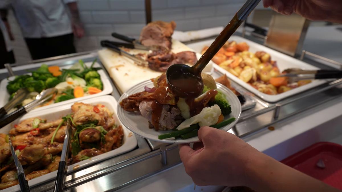Roast meat being served onto a plate at the onboard carvery